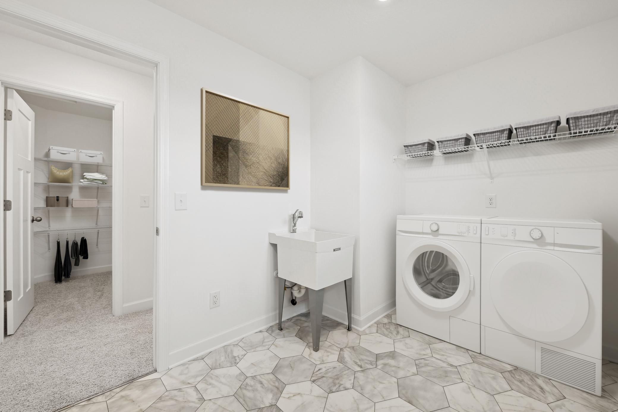 (Photo of a decorated model, actual homes finishes and colors will vary) Upper-level laundry.