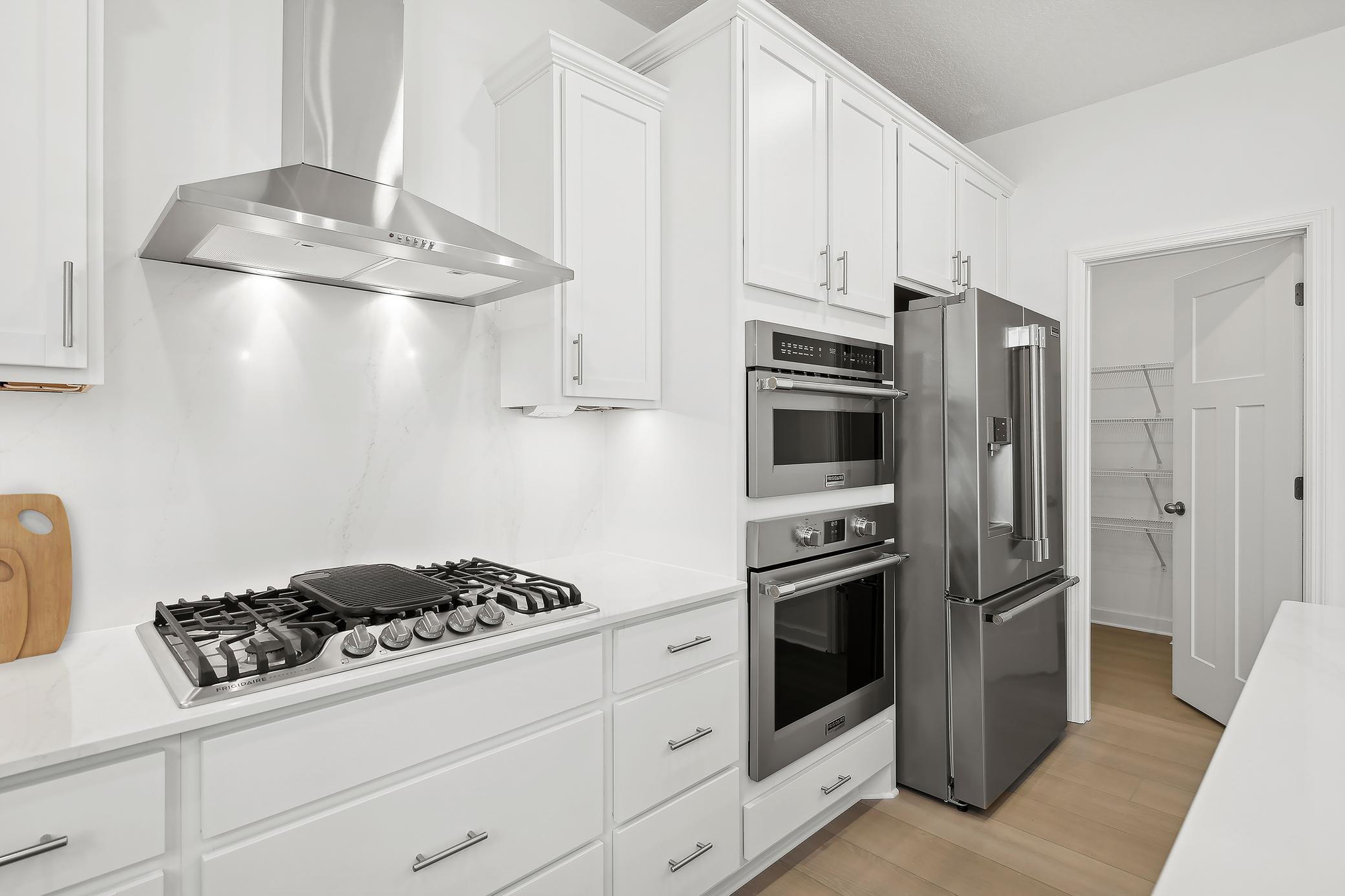 (Photo of a decorated model, actual homes finishes and colors will vary) The pantry is just off the kitchen.