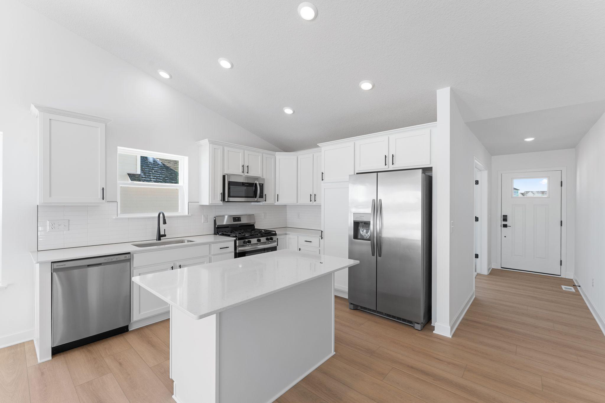 Designer-selected cabinetry throughout the kitchen offers ample storage room for dishware and daily culinary essentials