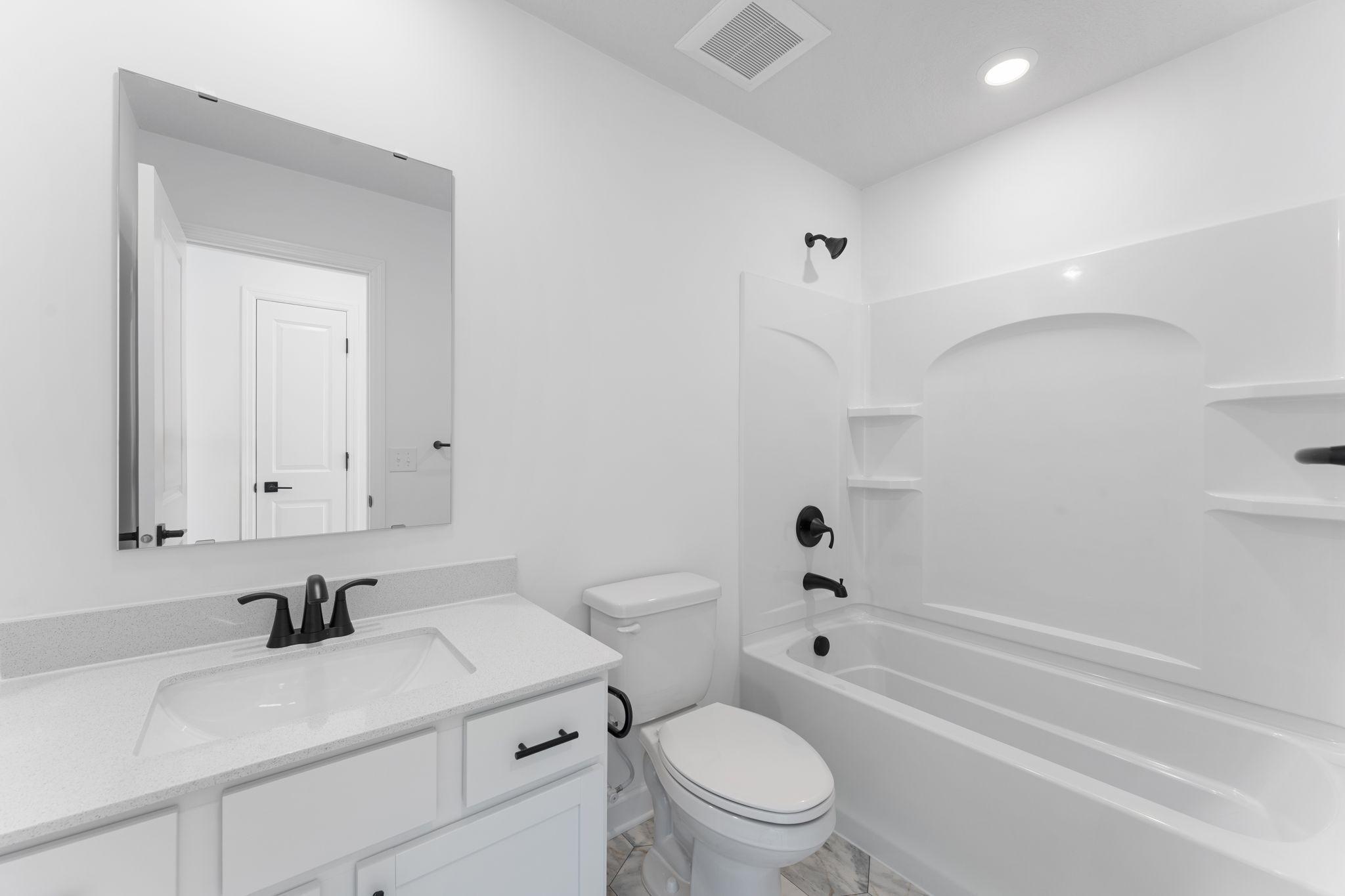 This full-sized bathroom is near the secondary bedrooms and features a single vanity and shower-tub combination.