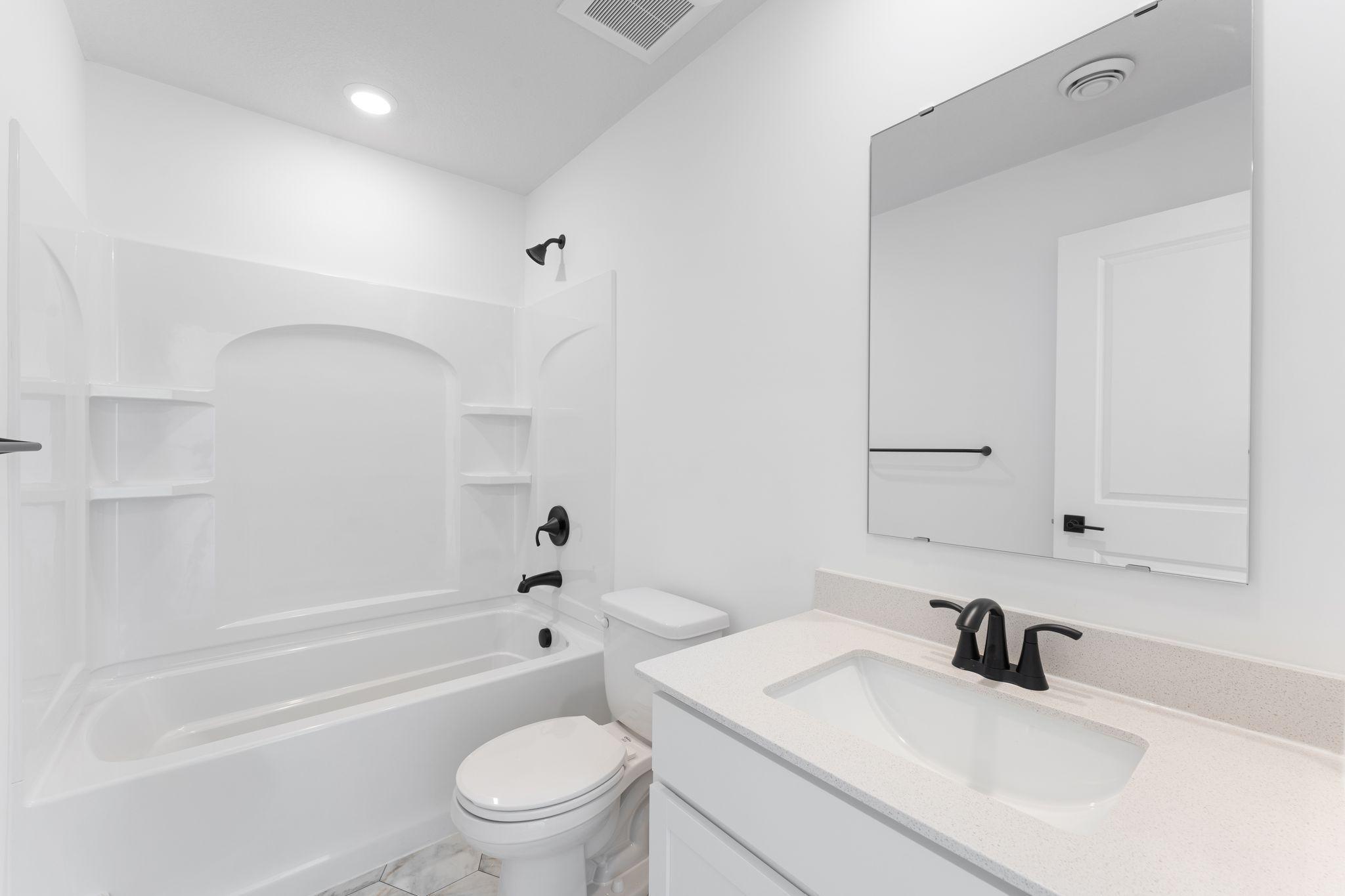 This full-sized bathroom is convenient for overnight guests staying in the adjacent secondary bedroom