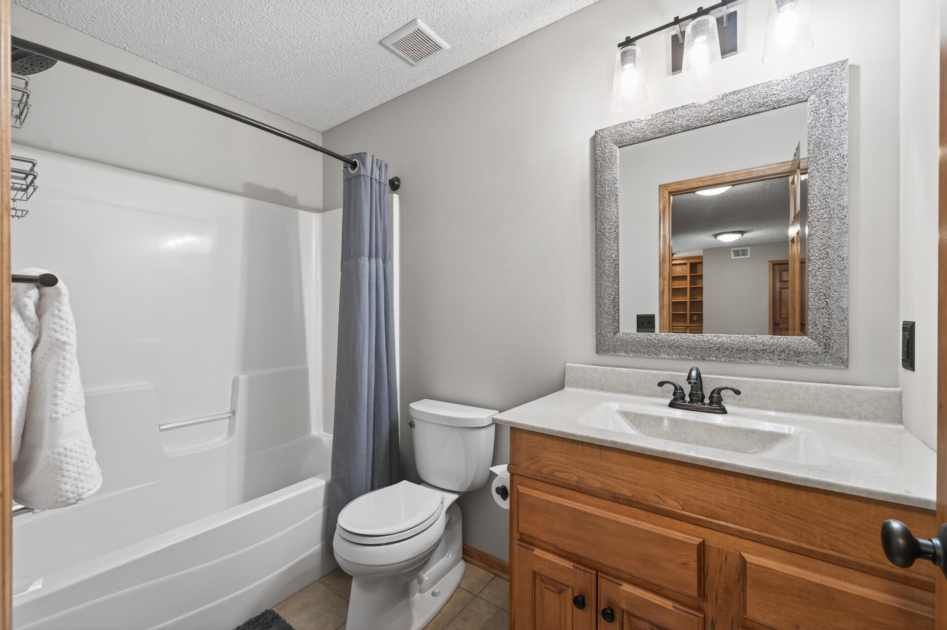 Full bathroom with neutral finishes, updated vanity, and a tub/shower combination, designed for both functionality and everyday convenience.