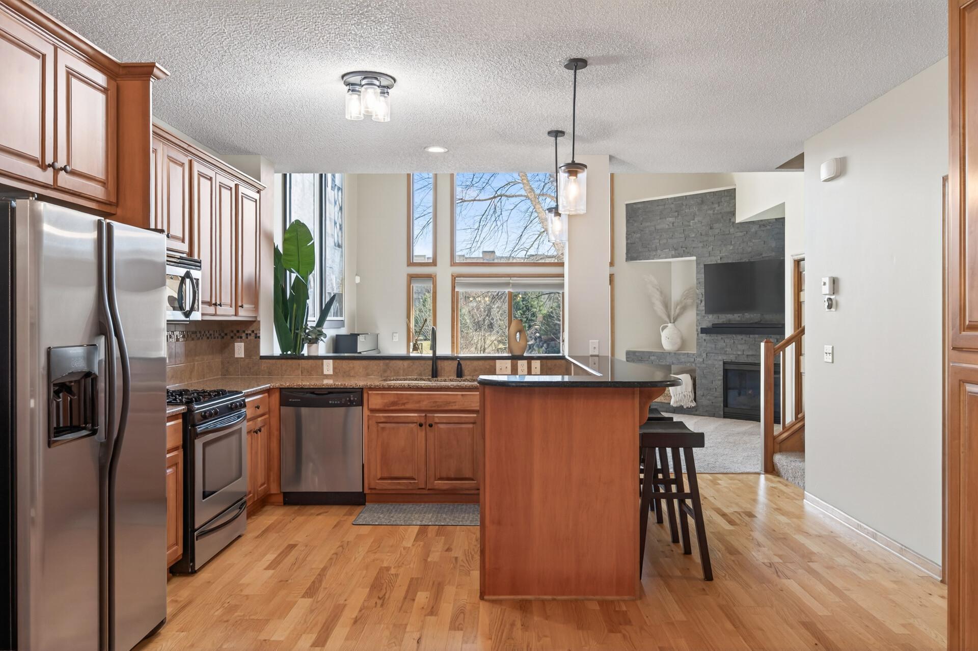 Spacious dining area with large windows and modern lighting, seamlessly connected to the kitchen. Ideal for hosting gatherings or enjoying daily meals.