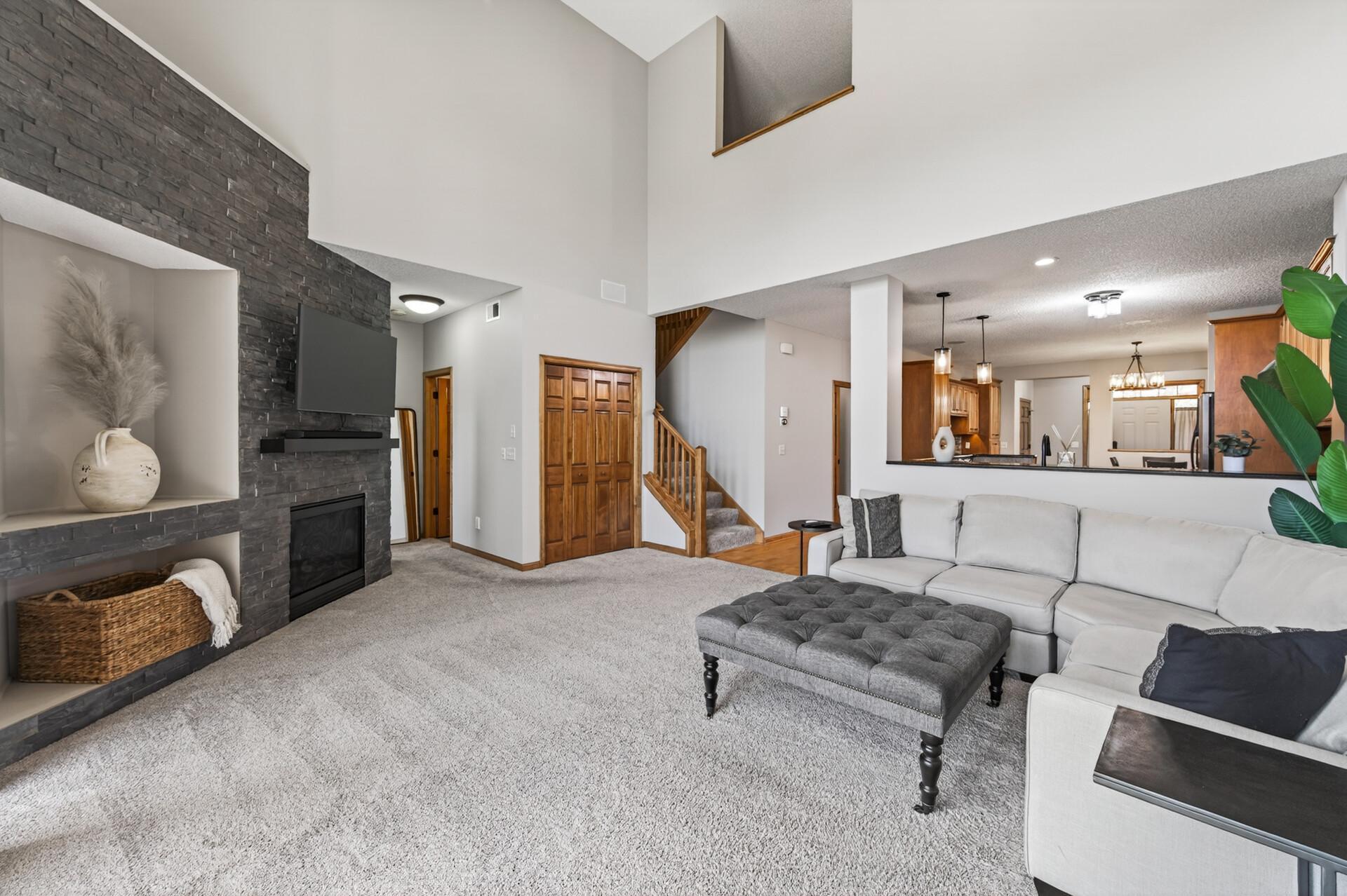 Bright living room highlighting architectural details and a cozy fireplace. The neutral palette complements a variety of design styles.