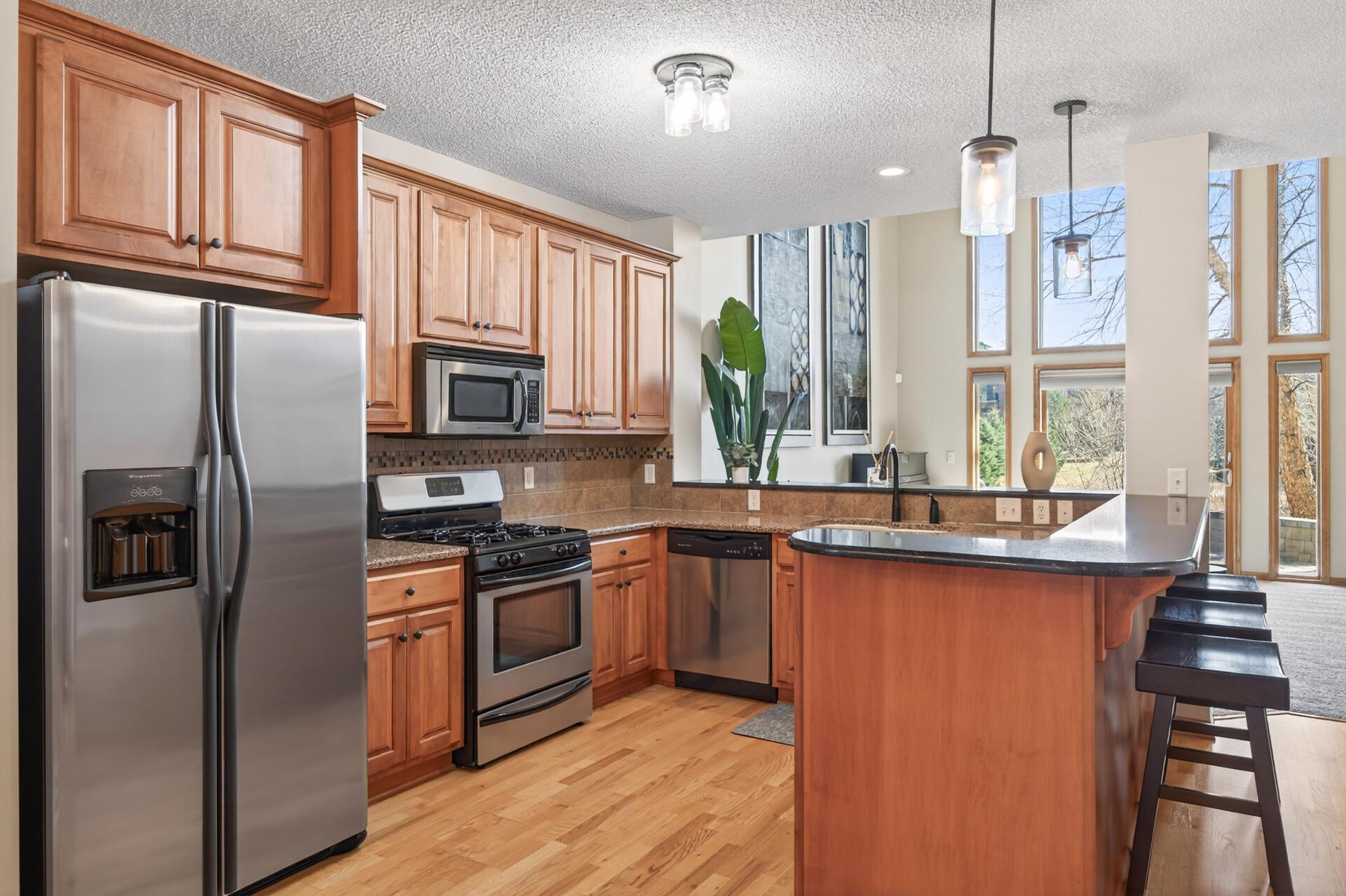 Well-appointed kitchen featuring stainless steel appliances, abundant cabinetry. Offers both style and practicality with ample prep space.