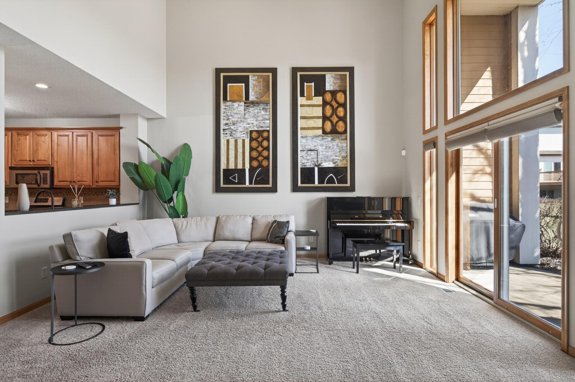 Bright living room highlighting architectural details and a cozy fireplace. The neutral palette complements a variety of design styles.