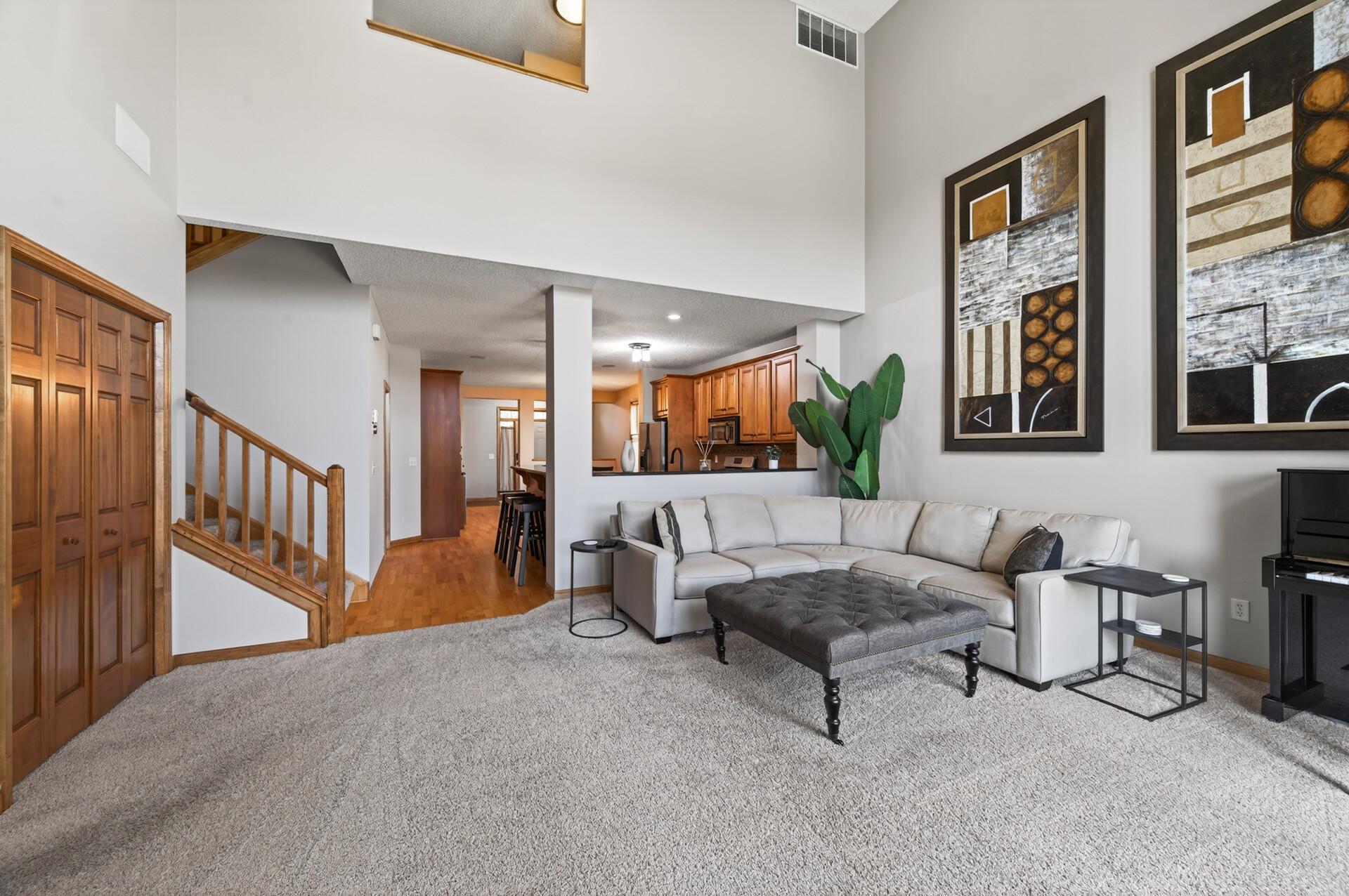 Alternate living room view highlighting soaring ceilings, modern finishes, and a comfortable, open layout—perfect for gathering and everyday living.