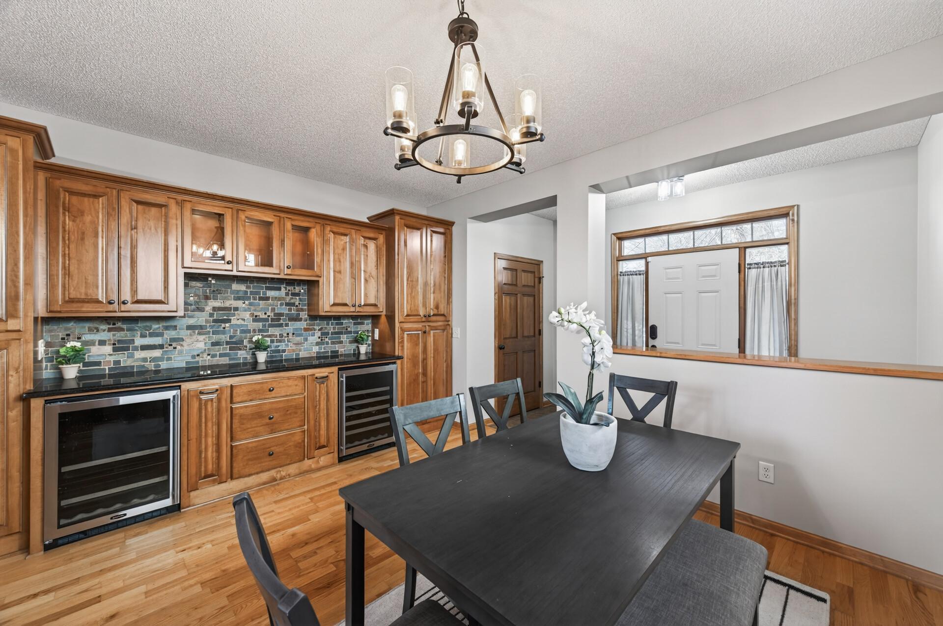 Dining area with clean sightlines to the entryway and kitchen, enhancing flow throughout the main level. Neutral finishes provide a move-in ready feel.