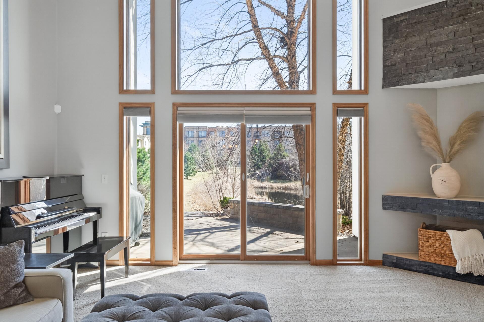 Living space with large sliding doors leading to a private patio and scenic outdoor views. Ideal for indoor-outdoor living and entertaining.