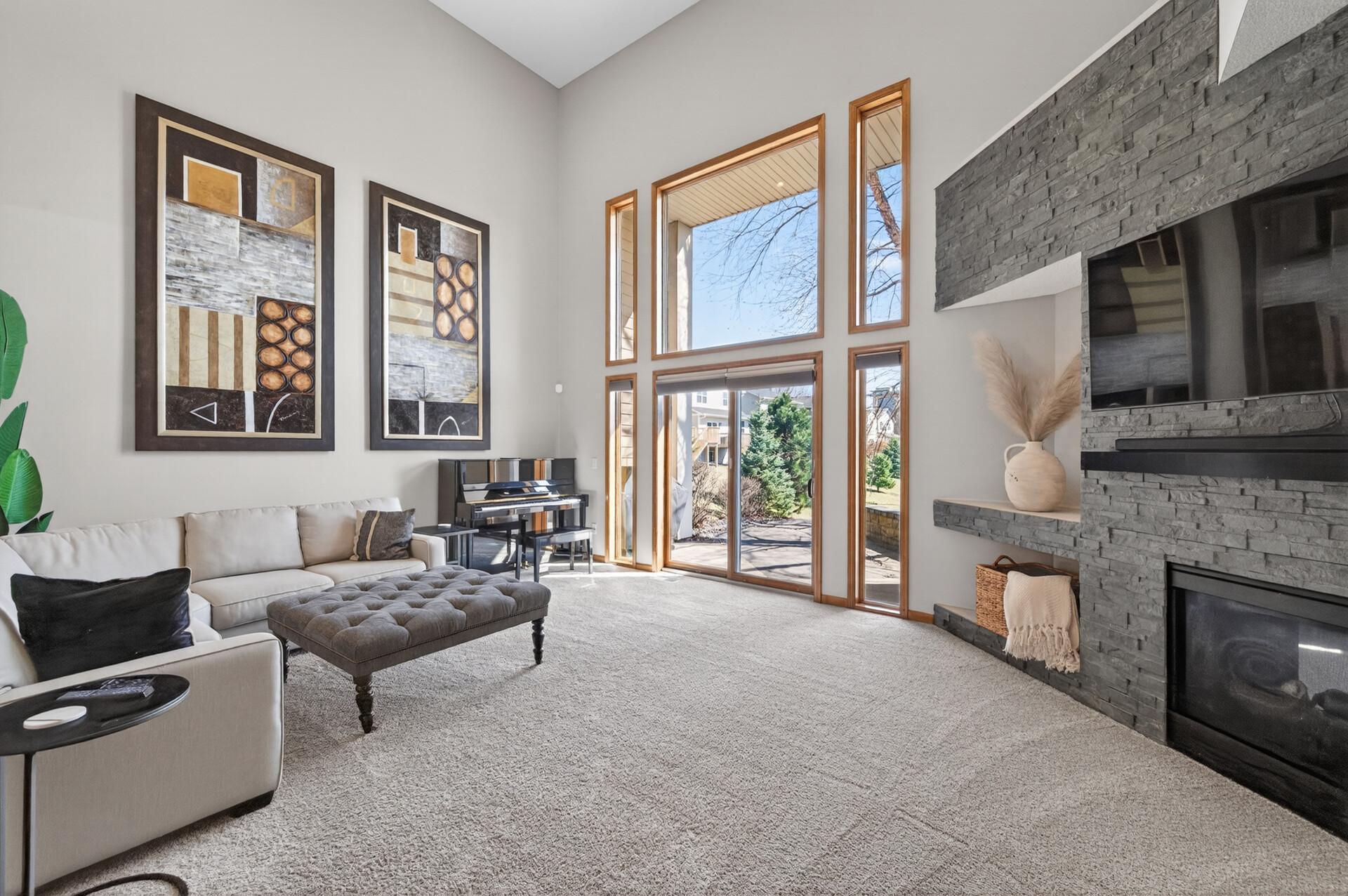 Floor-to-ceiling windows flood the space with natural light and showcase beautiful exterior views, enhancing the home’s open, airy feel.