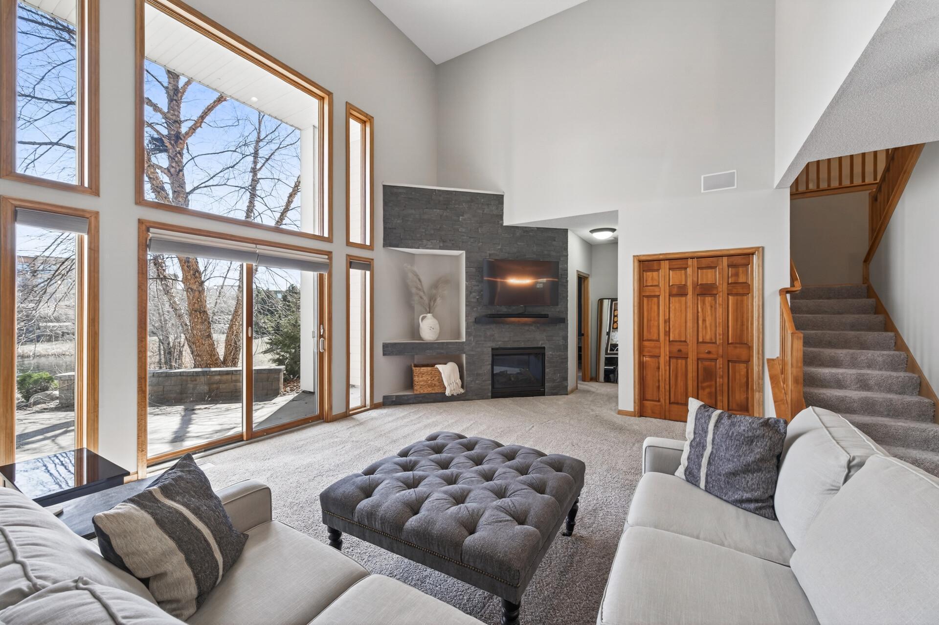 Stunning living area featuring a modern fireplace wall with sleek built-in shelving. Designed for both comfort and style, it’s the perfect space to relax or entertain guests.