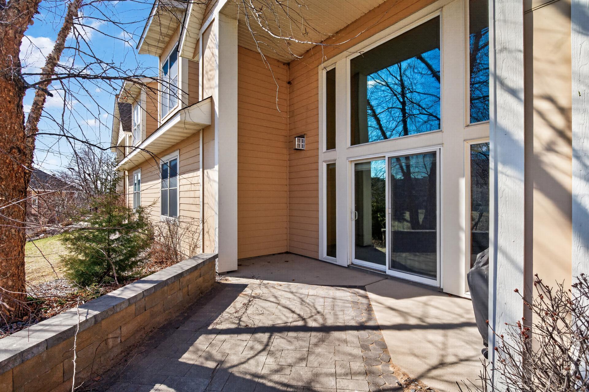 Rear exterior showcasing a well-maintained backyard with mature trees and a peaceful natural setting.