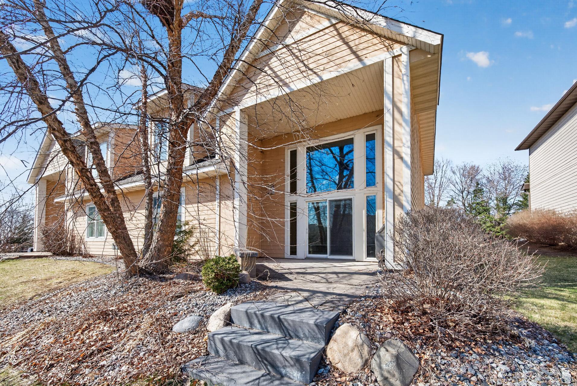Elevated rear view highlighting the home’s impressive architecture, large windows, and private outdoor living space.