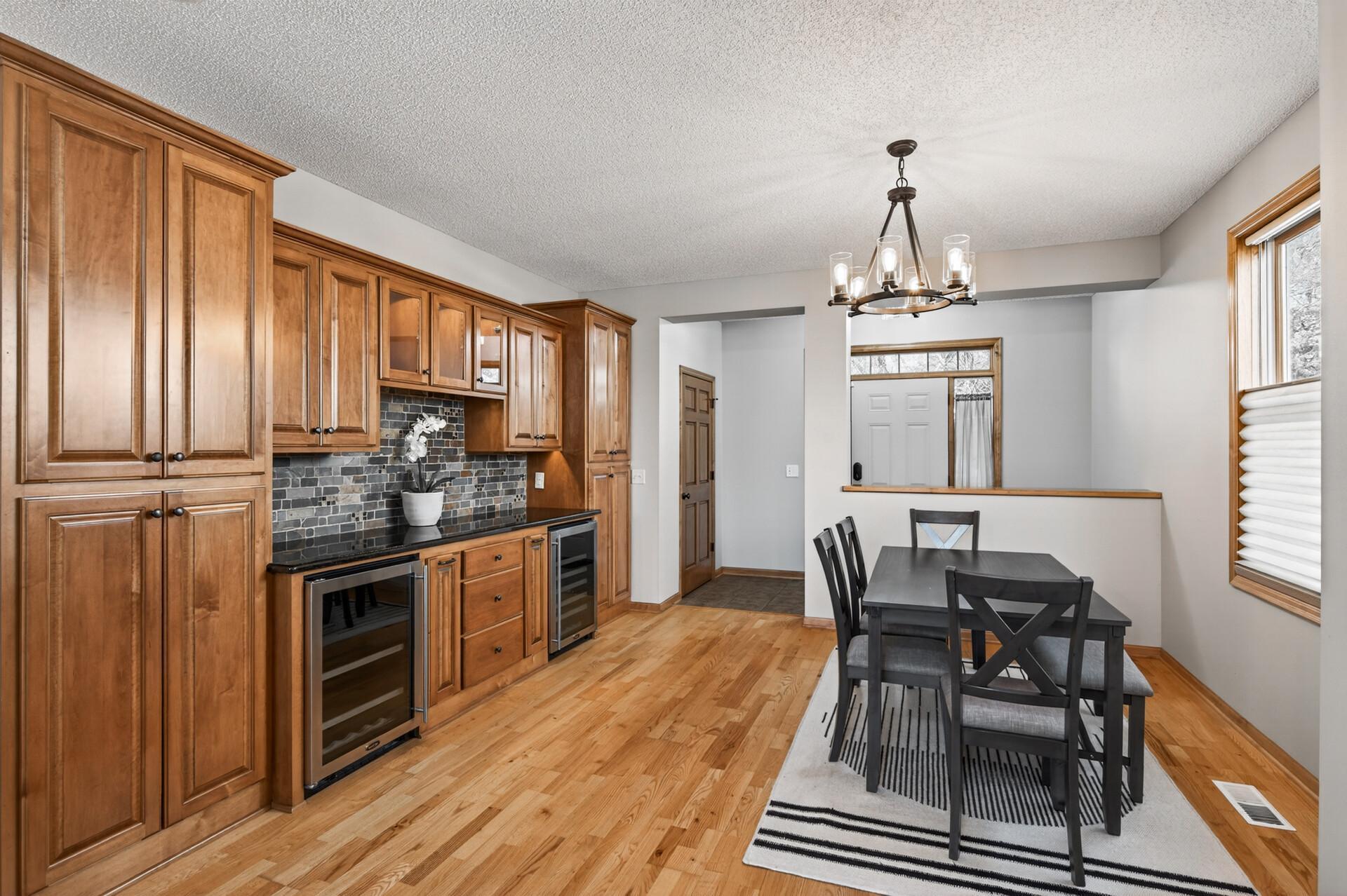 Additional dining perspective highlighting built-in cabinetry and beverage storage. A great extension of the kitchen for entertaining and convenience.