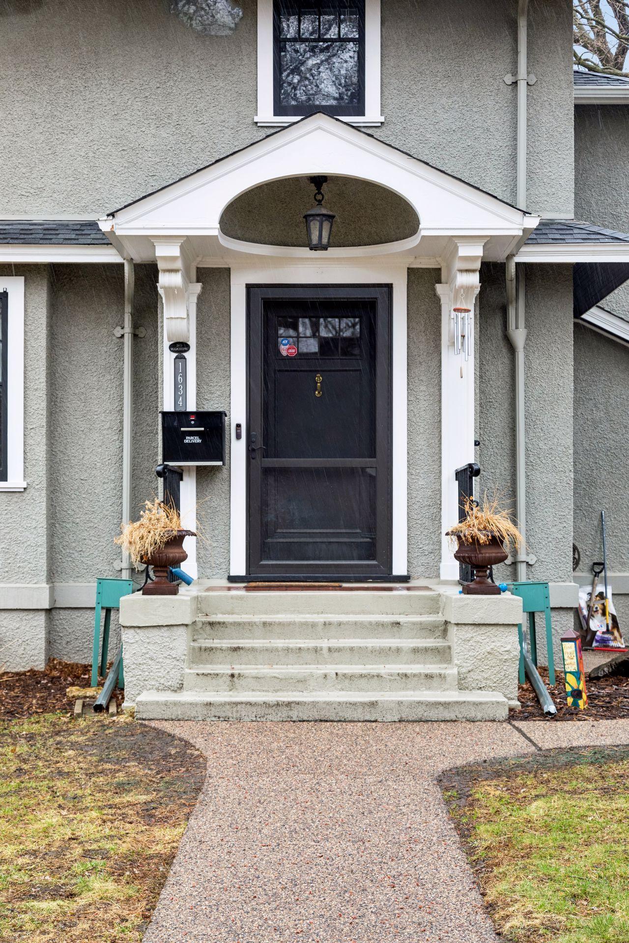 Gracious entry and orginal door as you approach - Renewal by Anderson entry doors are newer - there are security cameras alarm system installed