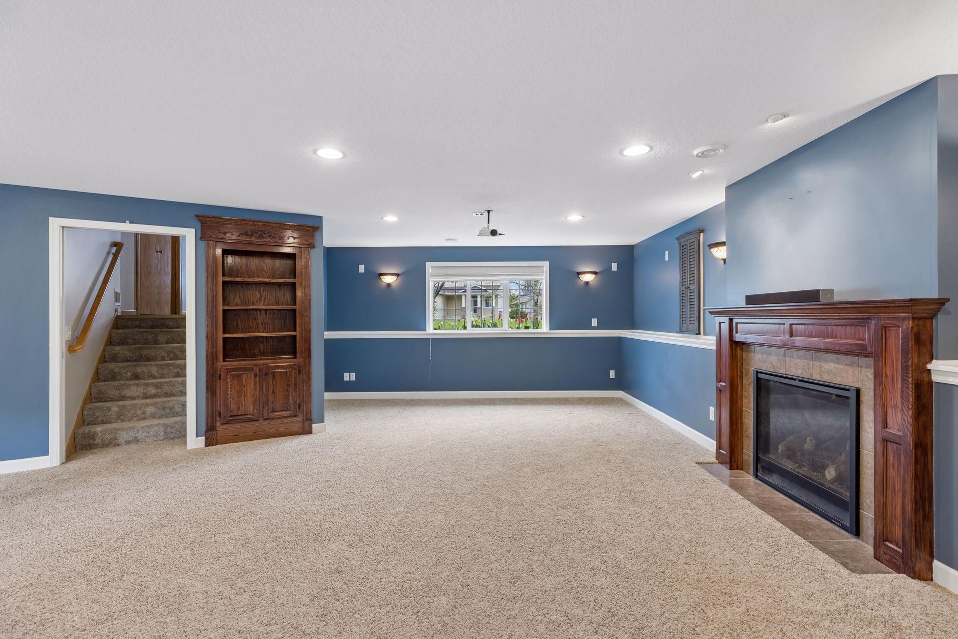 Warm and inviting lower-level family room featuring ample space for entertaining, movie nights, games, and everyday living.