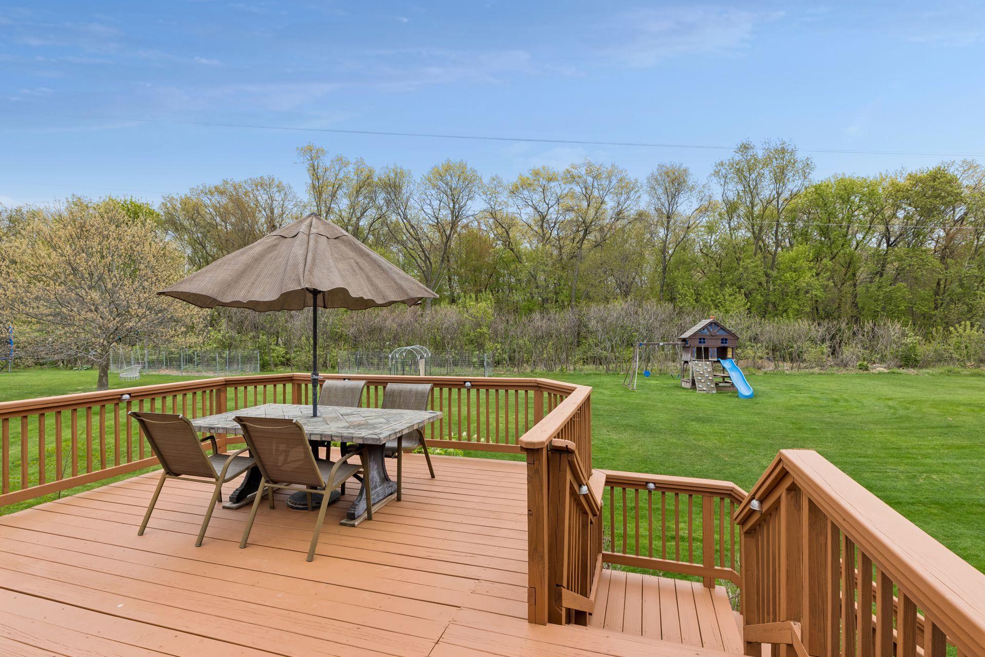 Expansive freshly stained deck overlooking the scenic backyard- the perfect place to enjoy morning coffee, summer dinners, and peaceful nature views with no rear neighbors in sight.