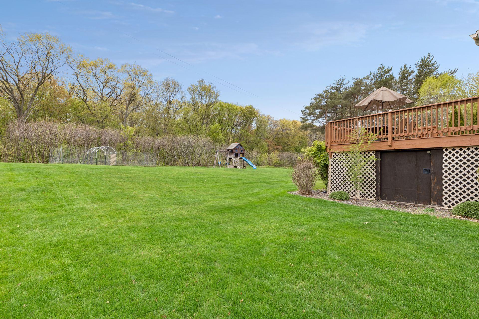Rare half-acre backyard setting with endless green space, garden and room to play, entertain, or simply relax. The deck also features convenient tucked-under storage space perfect for lawn equipment, outdoor tools, and seasonal storage.