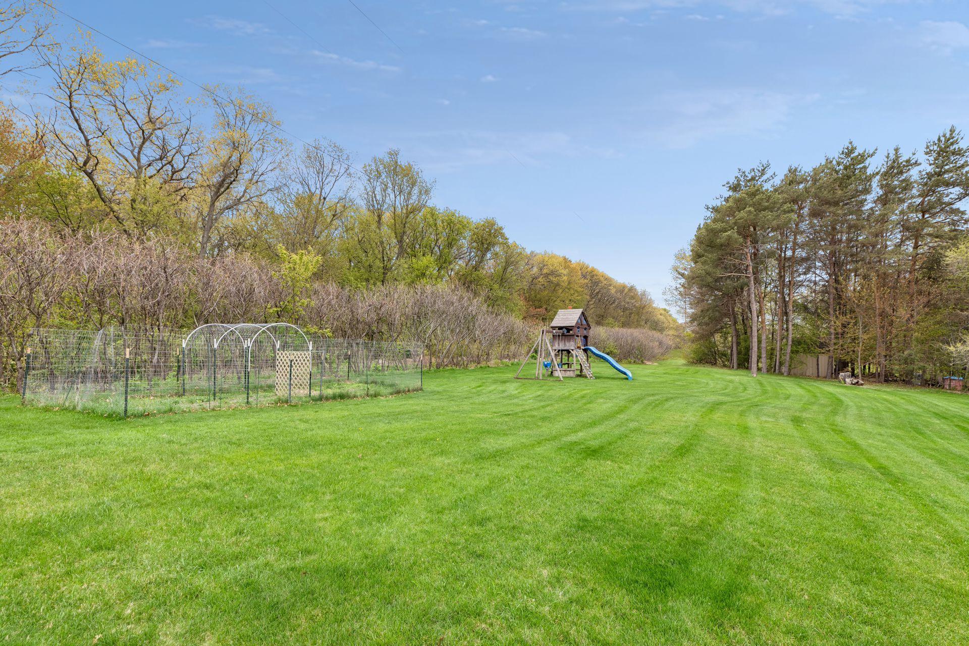 Enjoy wide open green space with a beautifully maintained backyard bordered by mature trees for added privacy.