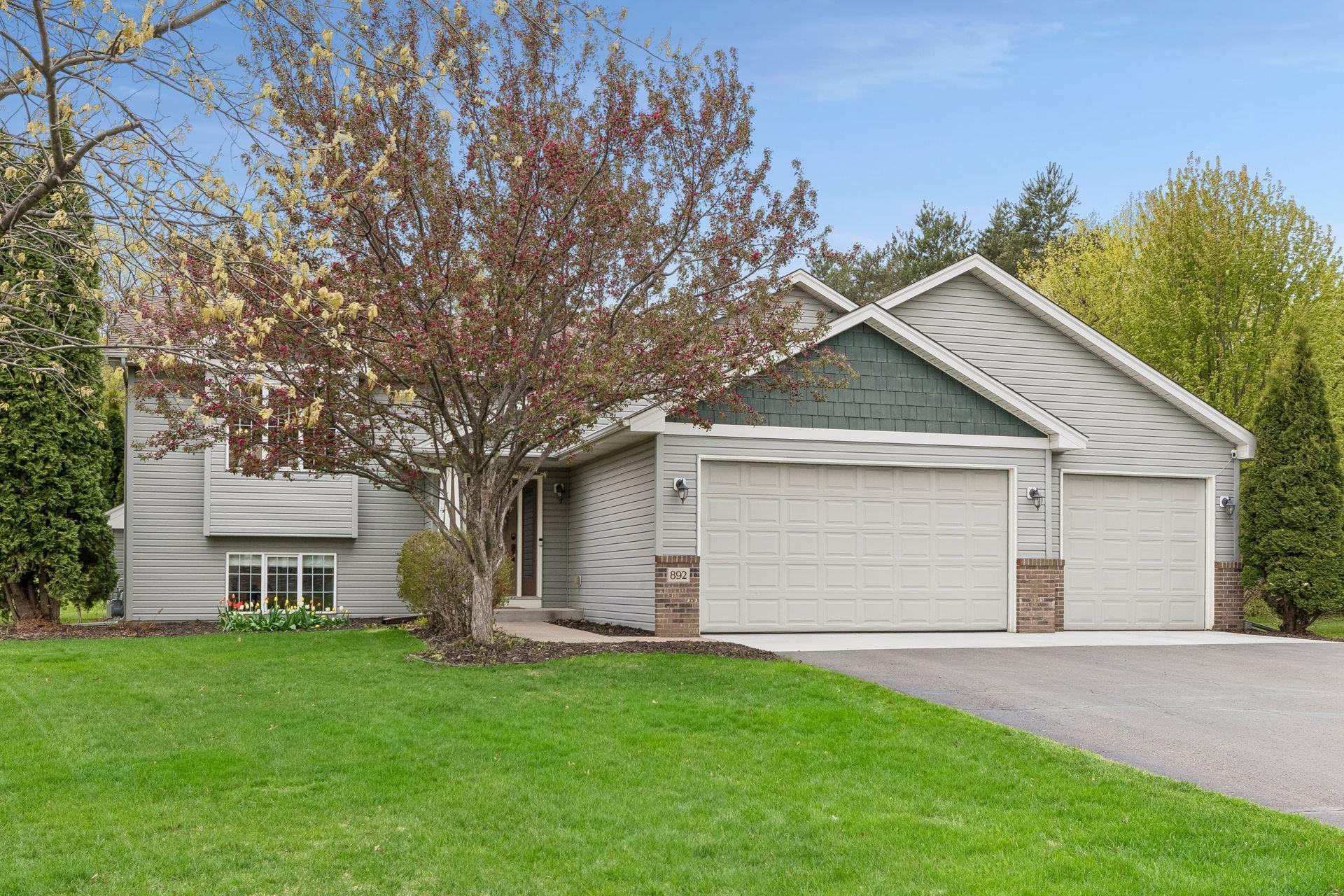 Charming curb appeal welcomes you home with mature landscaping, blooming trees, complementary siding and brick accents, and an oversized 3-car garage with an expansive driveway.