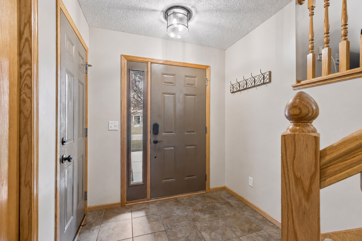 A welcoming and spacious entryway and convenient access to the oversized garage and upper level living spaces.