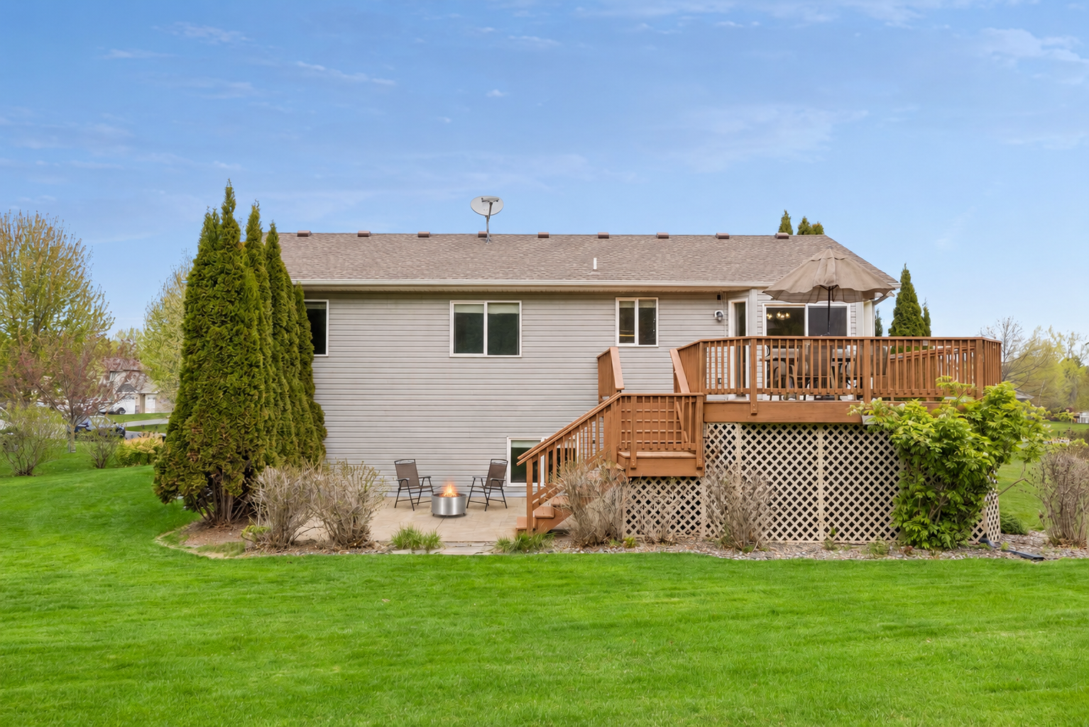 Step outside to enjoy the spacious backyard complete with an elevated deck, lower patio, and plenty of room to relax or entertain. Surrounded by mature trees and open green space, this outdoor setting offers the perfect blend of privacy and comfort.