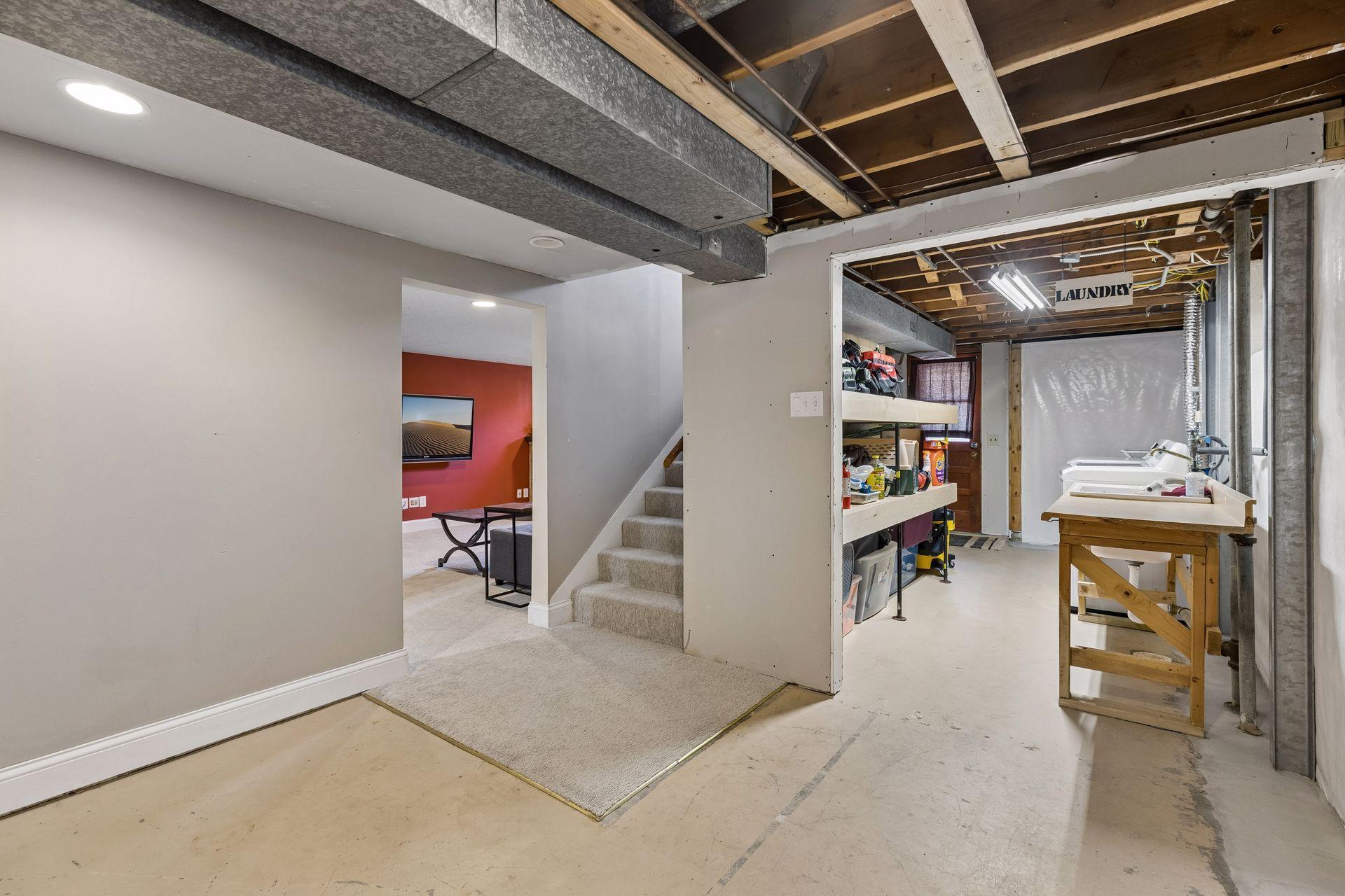 Spacious lower level with dedicated laundry area, ample storage, and unfinished space ready for future finishing or workshop use.