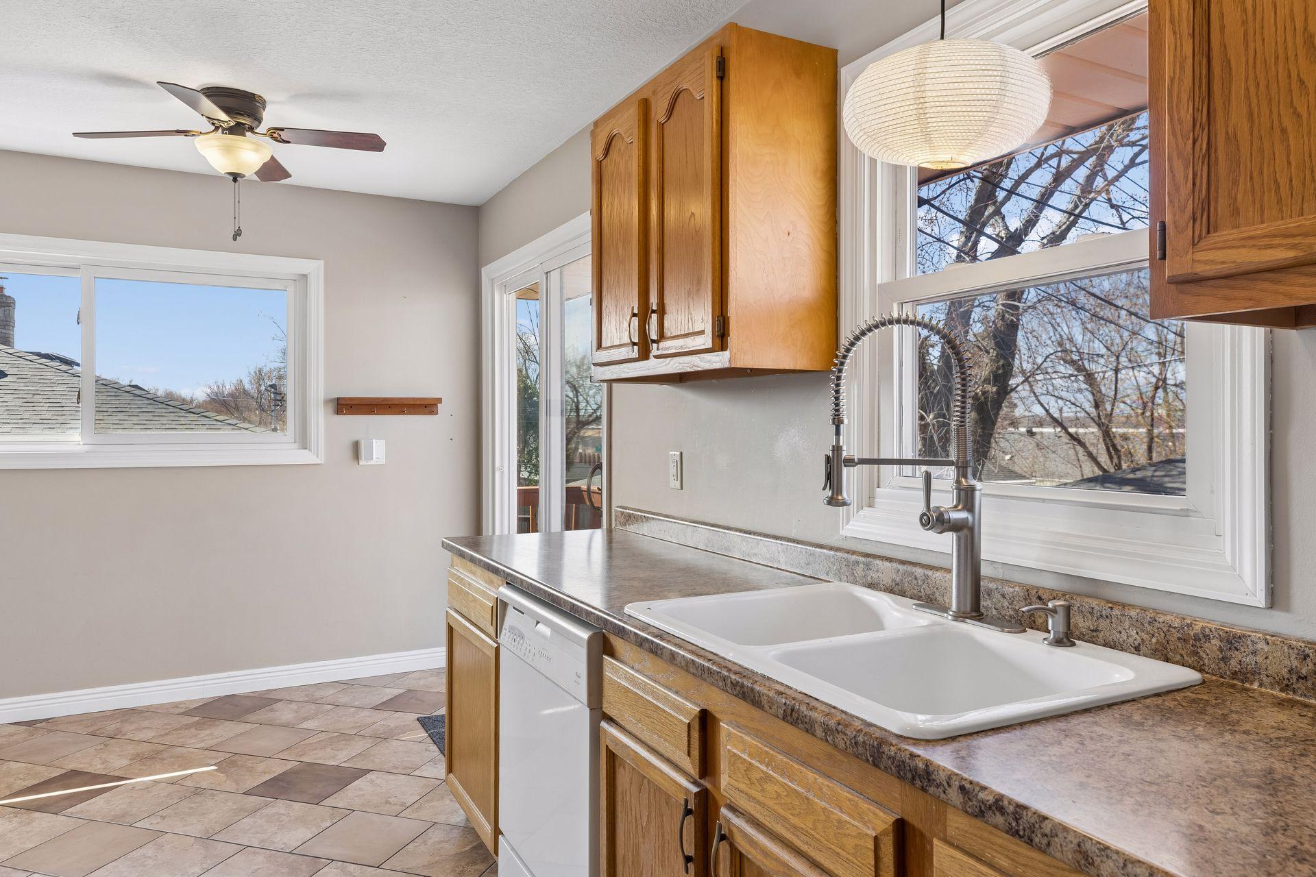 Kitchen with sink perfectly positioned under a large window, bringing in great natural light and backyard views.