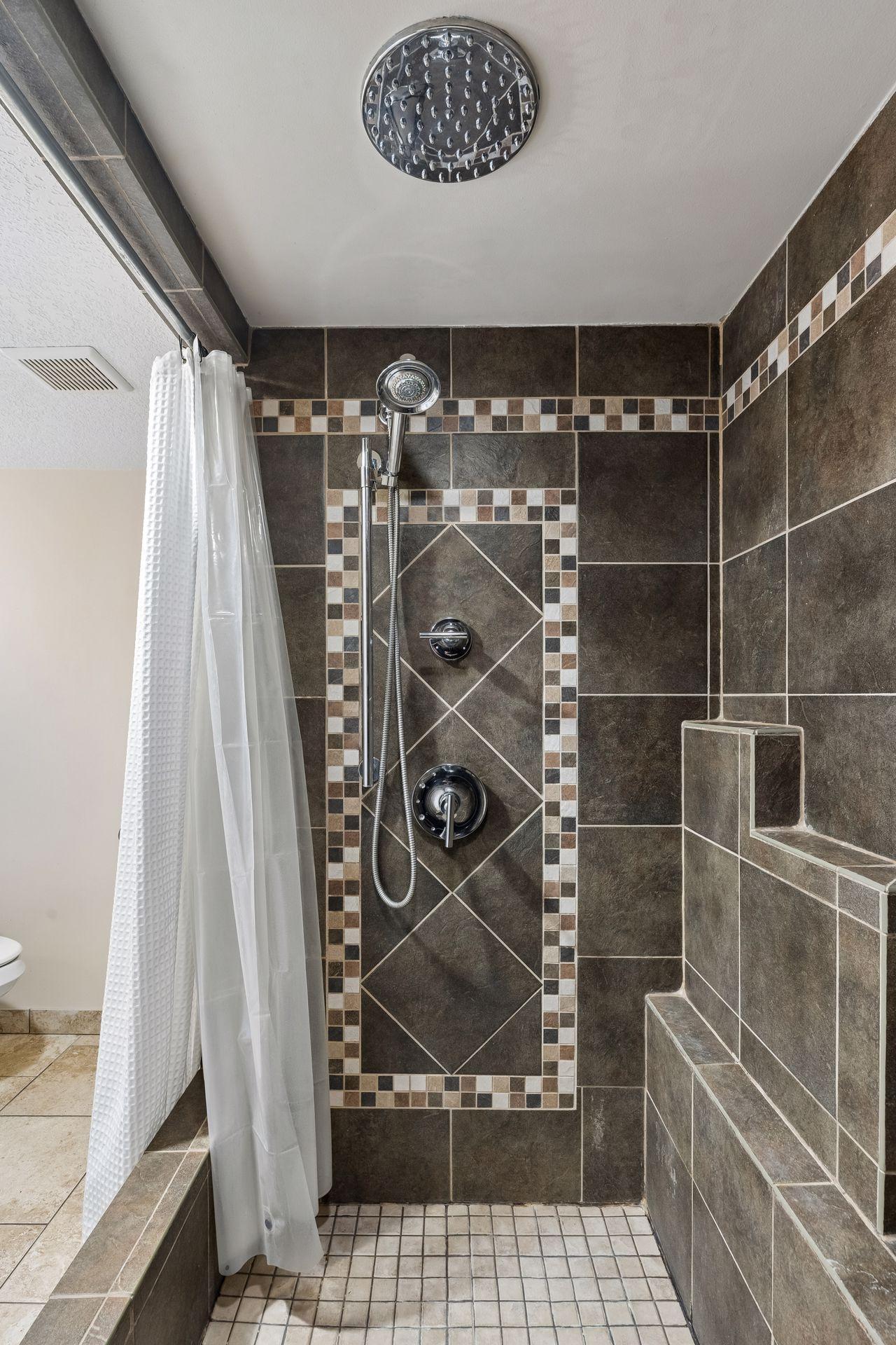 Another look at the spacious walk-in shower, complete with a rain shower head for a relaxing, spa-like feel.