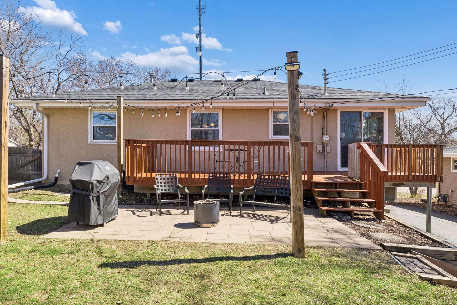 Backyard patio and deck combo—perfect for outdoor entertaining with café string lights adding a warm evening ambiance.