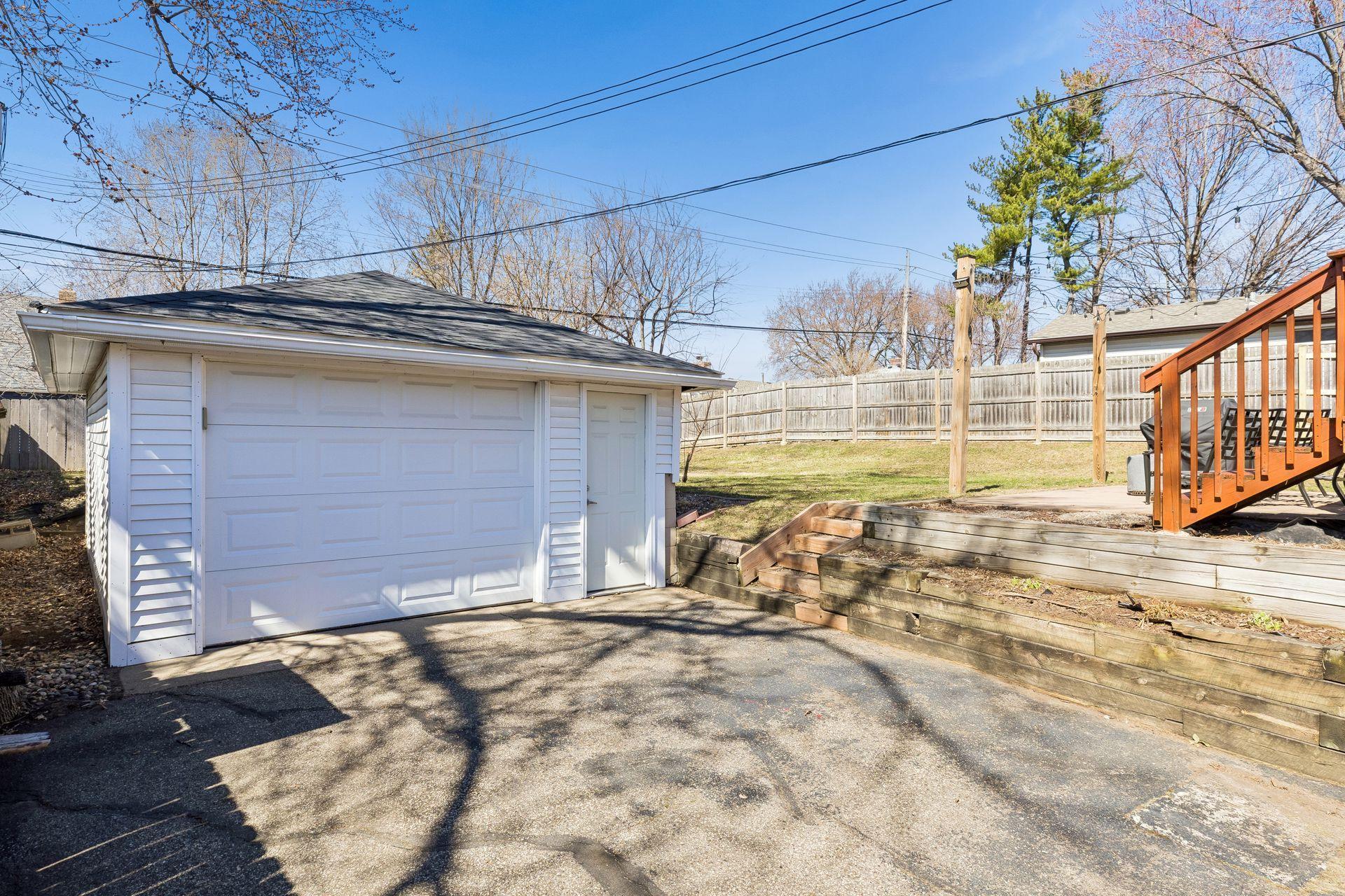 Detached garage with additional storage space, plus deck and backyard ready for outdoor enjoyment.