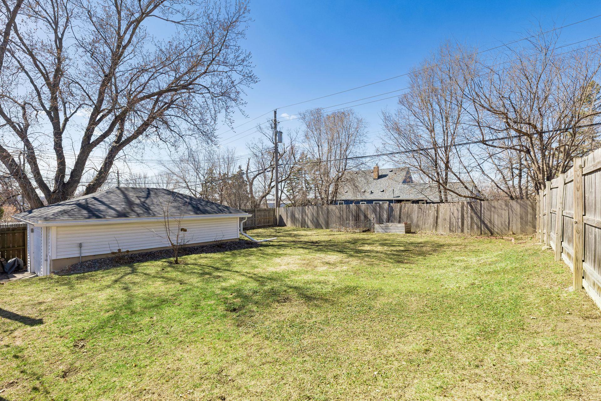 Spacious, partially fenced backyard with room to play, garden, or relax.