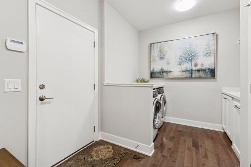 A spacious Laundry room and mud room with pocket doors