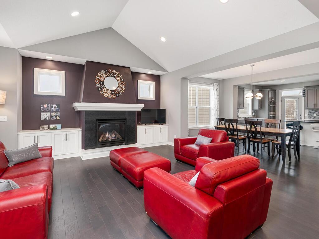 Living room centered around fireplace with built-ins and great natural light.