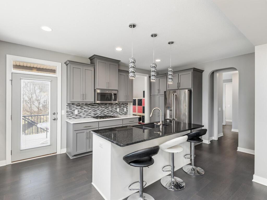 Functional layout with center island, gas cooktop, and easy access to outdoor deck.