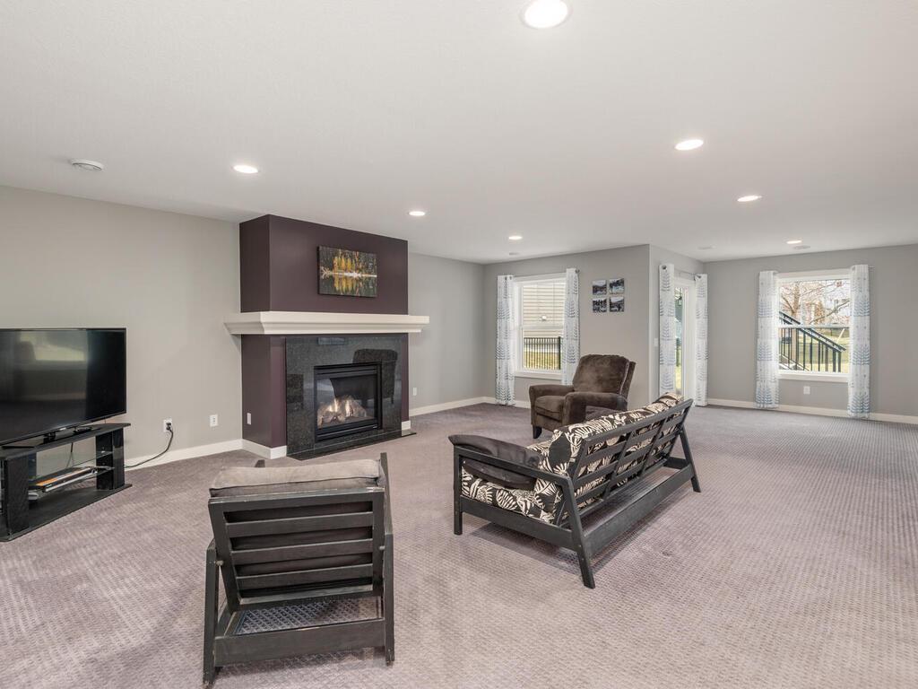 Expansive lower-level family room with gas fireplace and flexible layout.