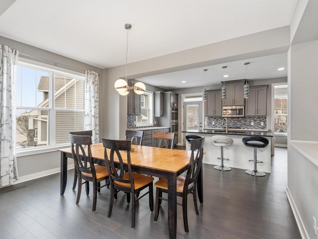 Dining area with large windows and seamless flow to the kitchen.