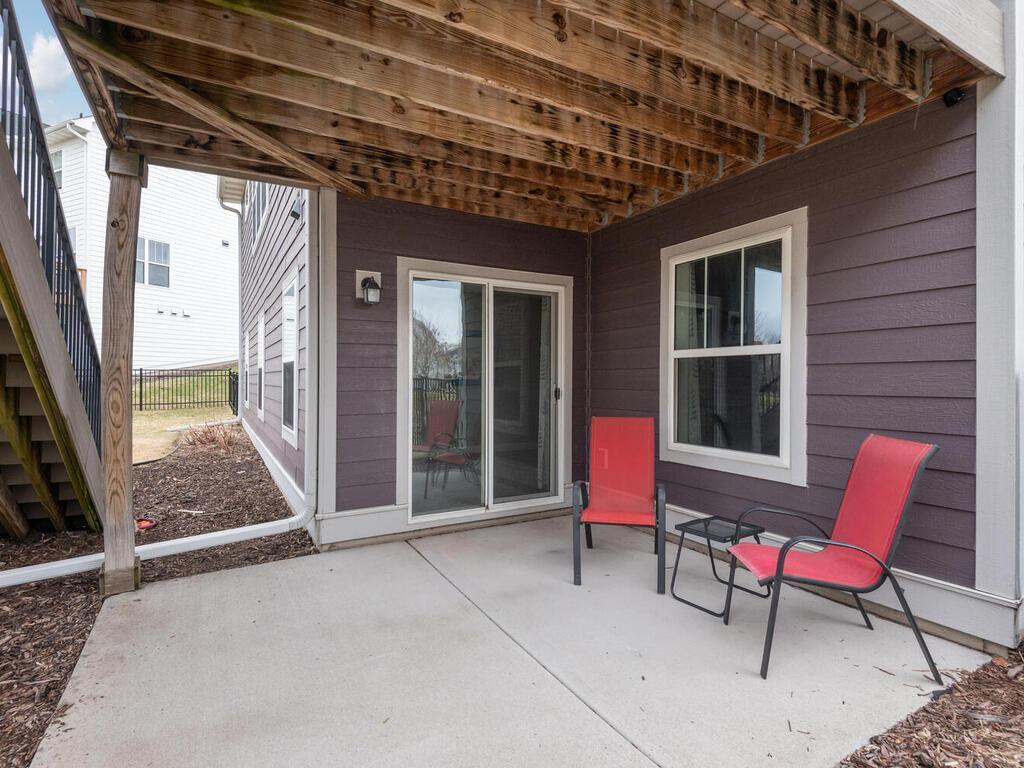 Lower-level patio with walkout access and shaded seating area.