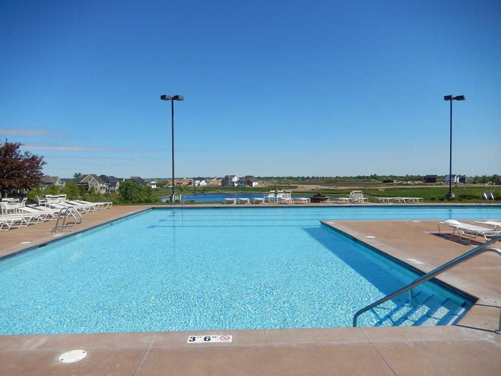 Large outdoor pool with surrounding lounge areas and scenic views.