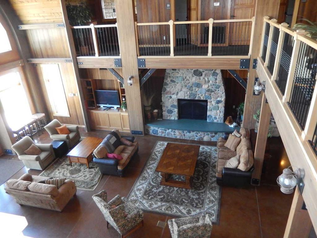 Clubhouse interior with two-story great room, fireplace, and seating areas.