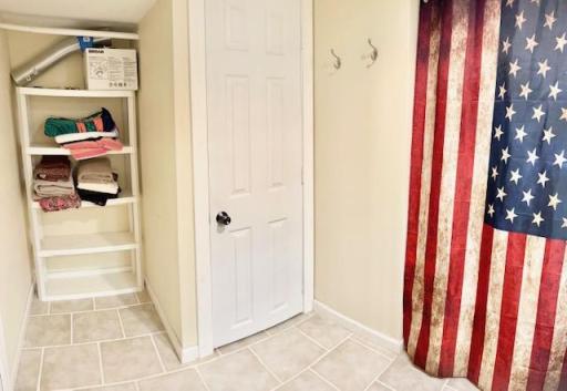 Another view of the basement 3/4 bath with linen closet and storage