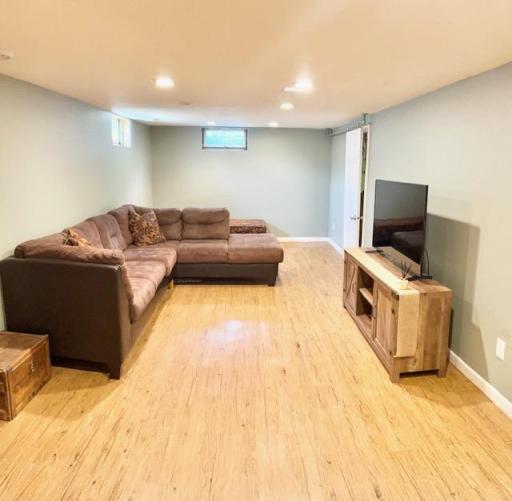 Large Basement family room with recessed lighting