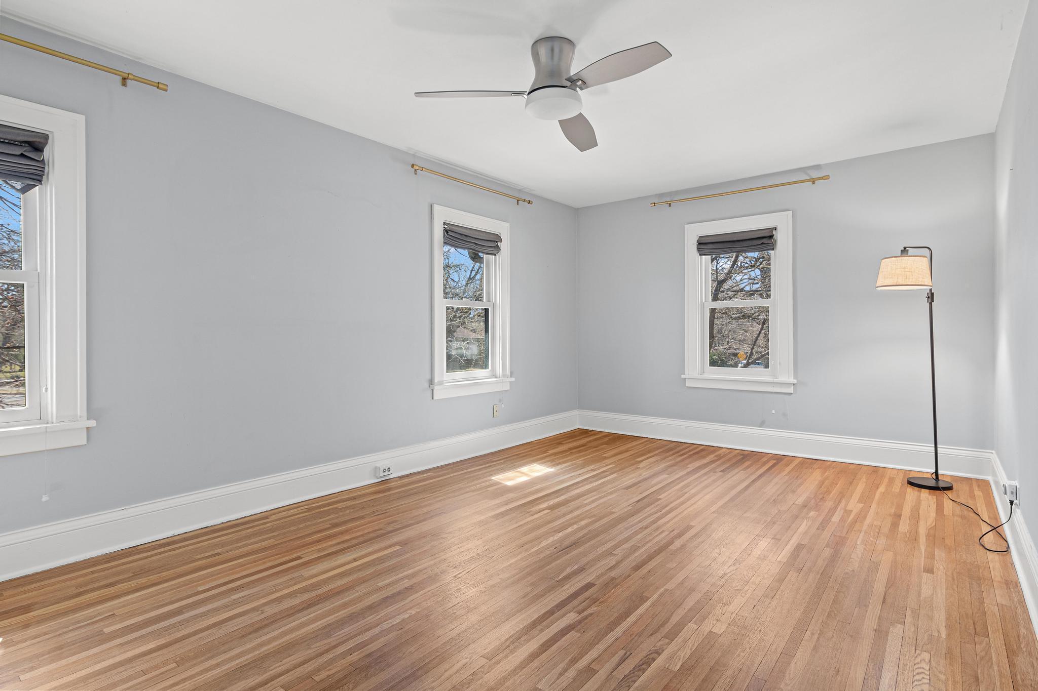 Spacious primary bedroom with classic character.