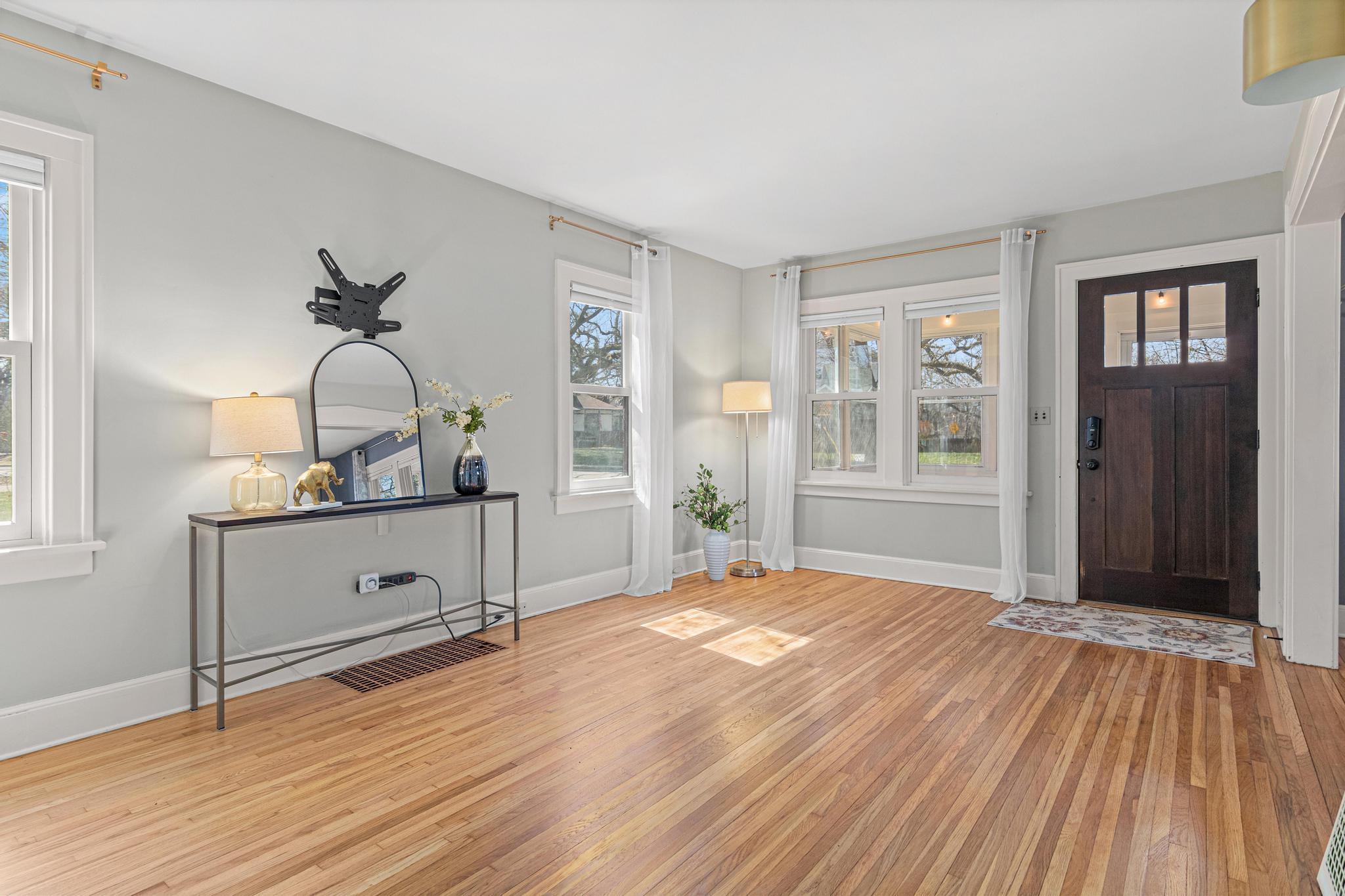 Oversized living room filled with natural light- perfect space for entertaining or movie nights.