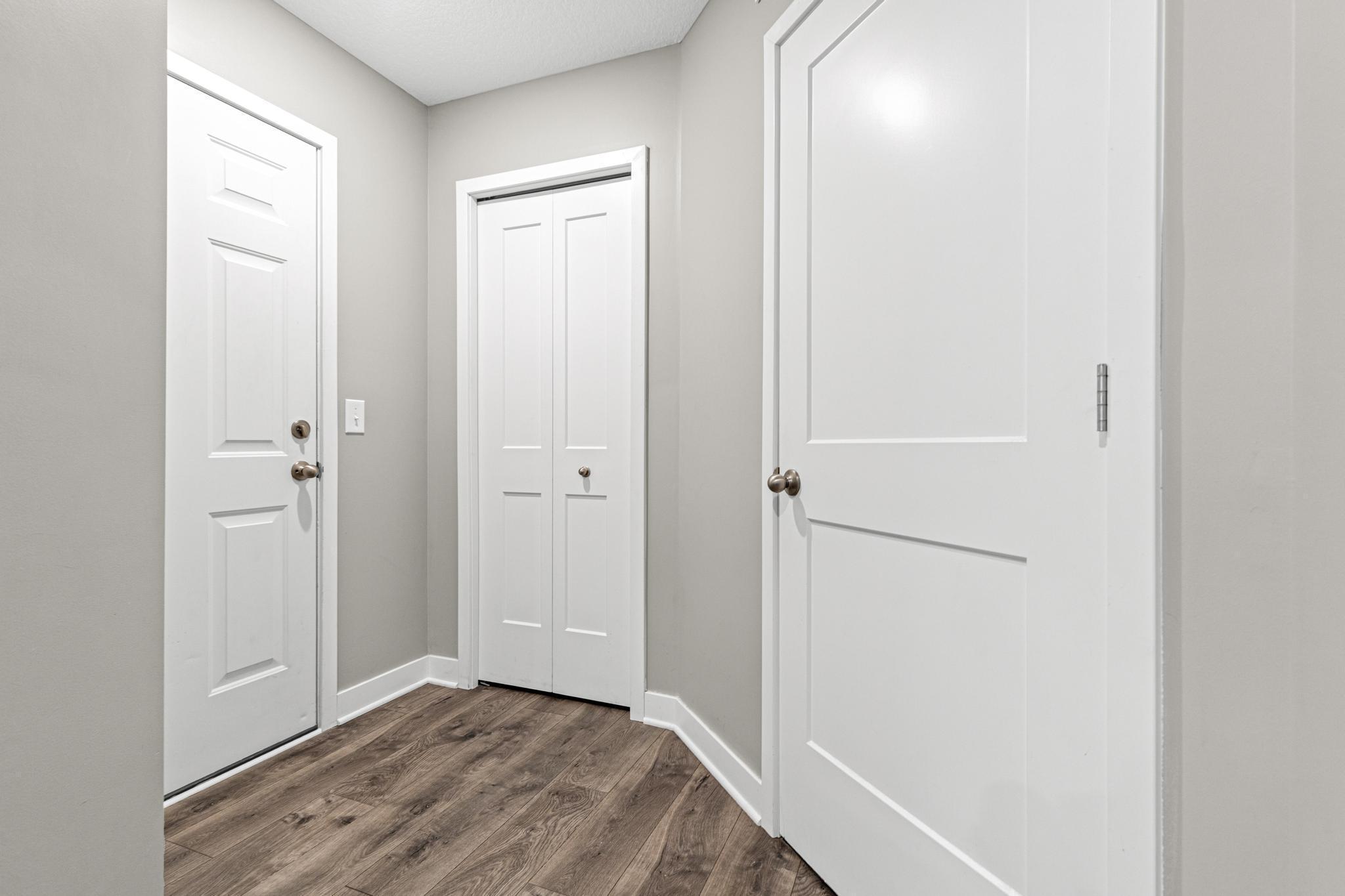 Practical service hallway connecting the 2-car garage to the main home. This functional space features a closet and the utility room, keeping essentials tucked away while providing a perfect "drop zone" for daily entry.