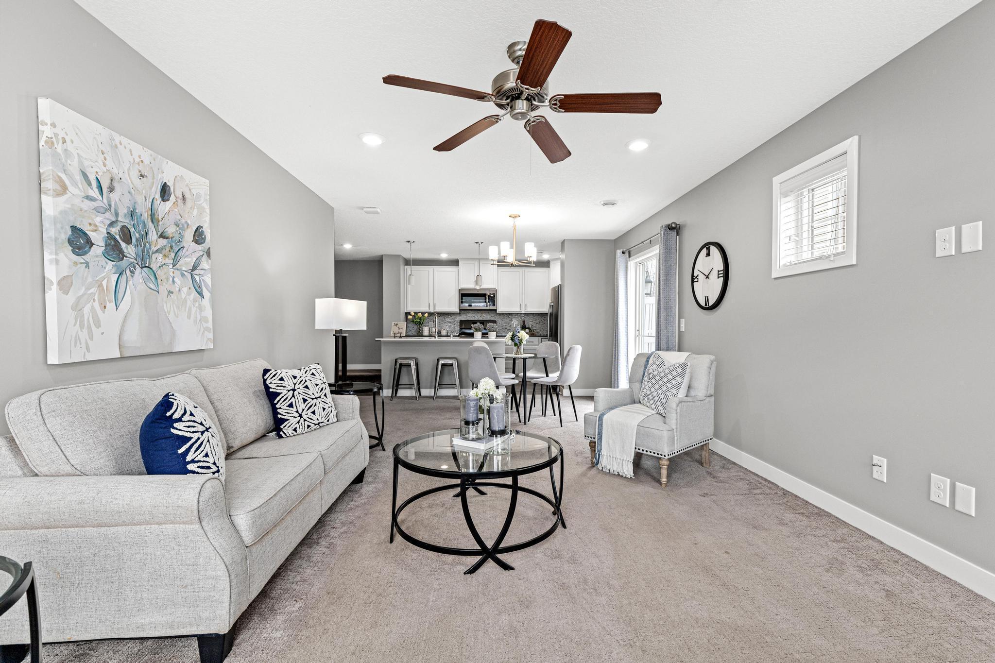 View from the entryway leading into the heart of the home, featuring direct access to the private side patio. This layout perfectly blends the open kitchen and living areas with outdoor relaxation space.