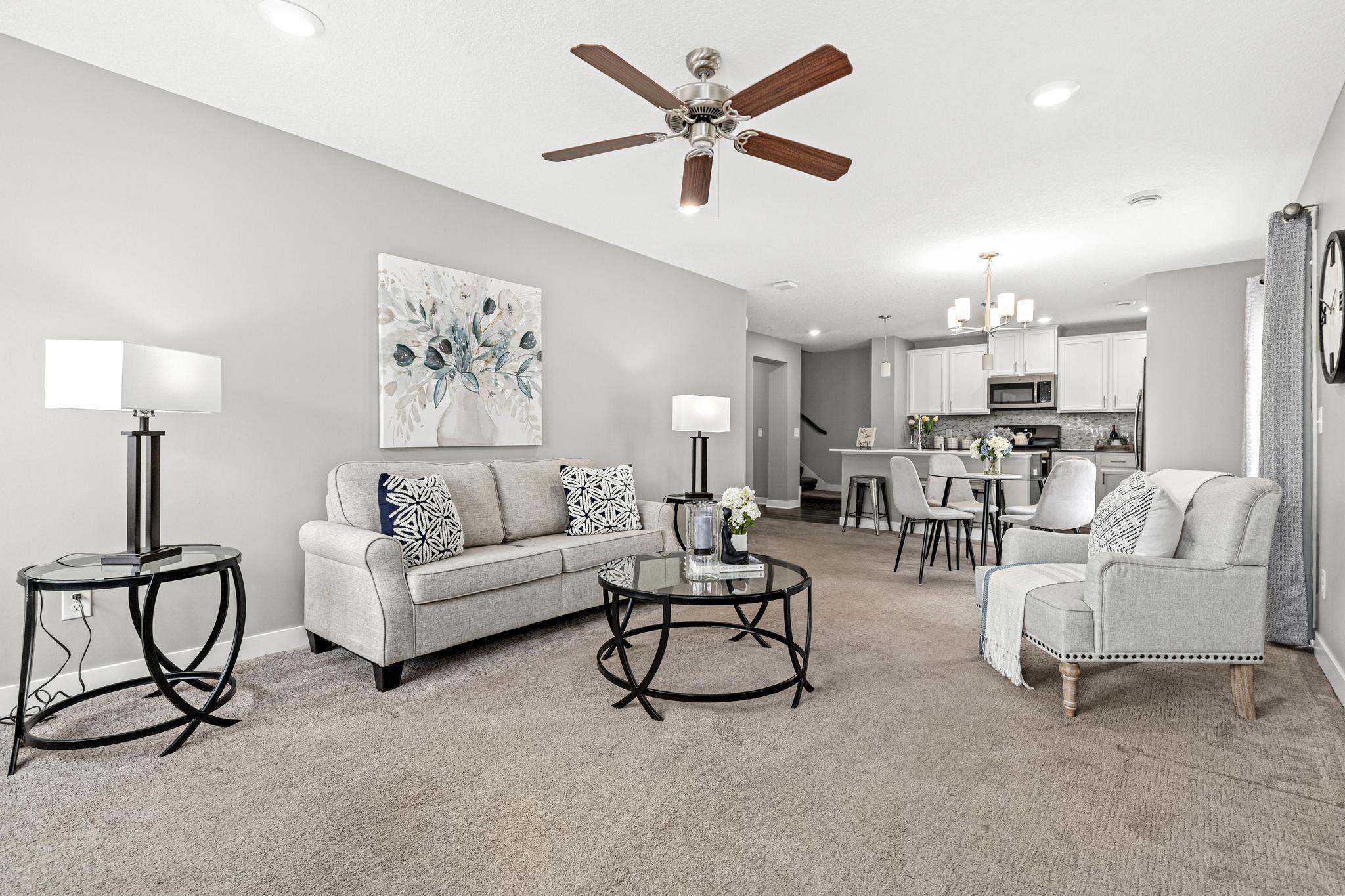 A wide-angle view from the front entrance showcasing the seamless transition into the heart of the home. The open sightlines to the kitchen highlight the quartz island and contemporary 2018 finishes.