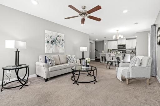 A wide-angle view from the front entrance showcasing the seamless transition into the heart of the home. The open sightlines to the kitchen highlight the quartz island and contemporary 2018 finishes.