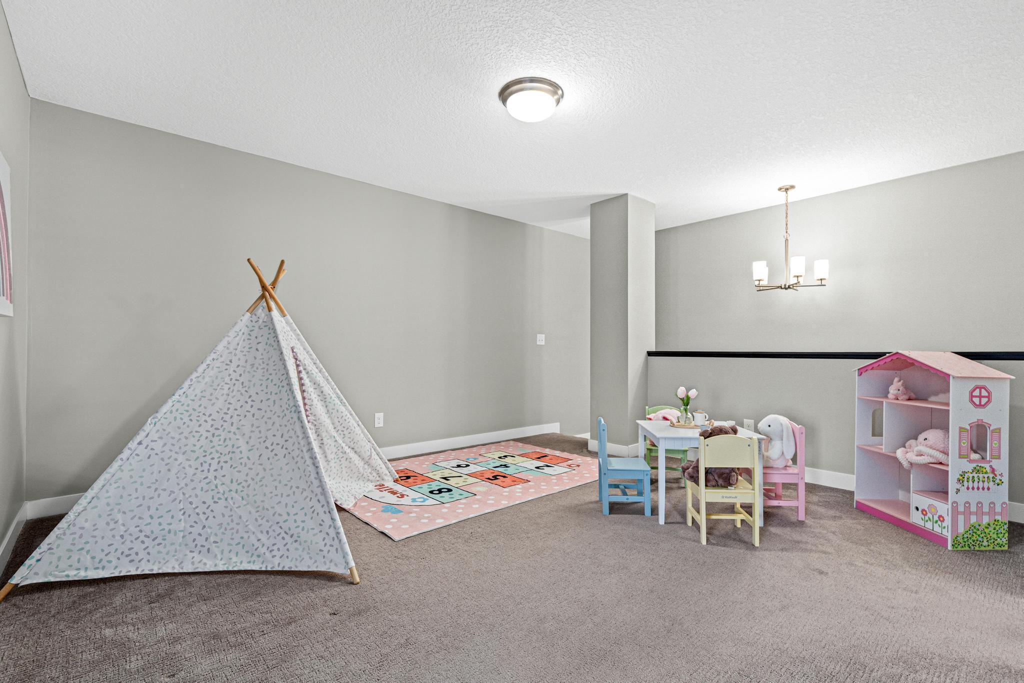 Versatile upper-level loft offers a flexible secondary living space, perfect for a home office, media room, or play area. This multi-functional landing separates the primary suite from the guest bedrooms.