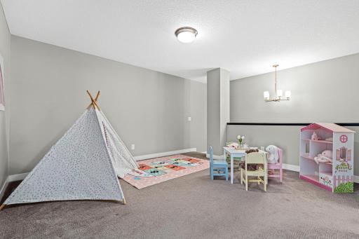 Versatile upper-level loft offers a flexible secondary living space, perfect for a home office, media room, or play area. This multi-functional landing separates the primary suite from the guest bedrooms.